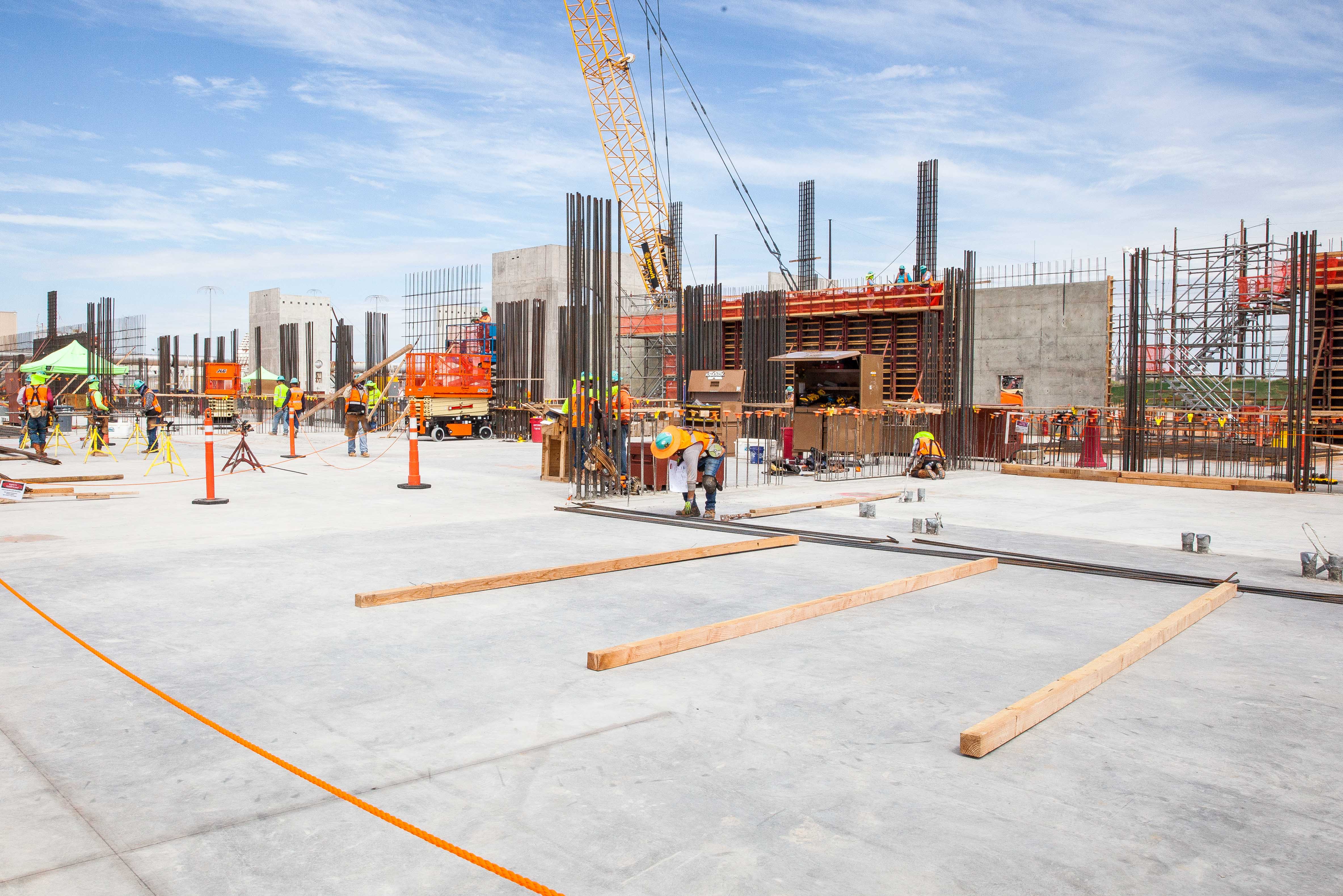 Workers erecting walls of the 55,000 square-foot building